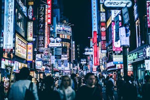 Pessoas andando nas ruas de um bairro badalado de Tóquio, chamado Shibuya.